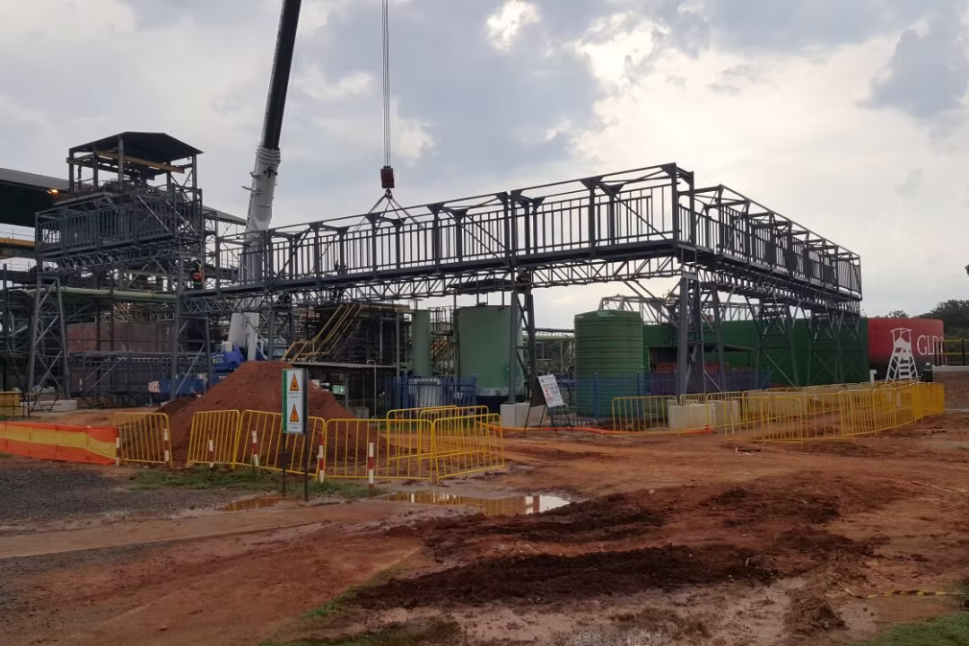 Steel walkway module being lifted into position on site by mobile crane